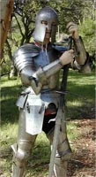 Person in 15th C Italian plate armour